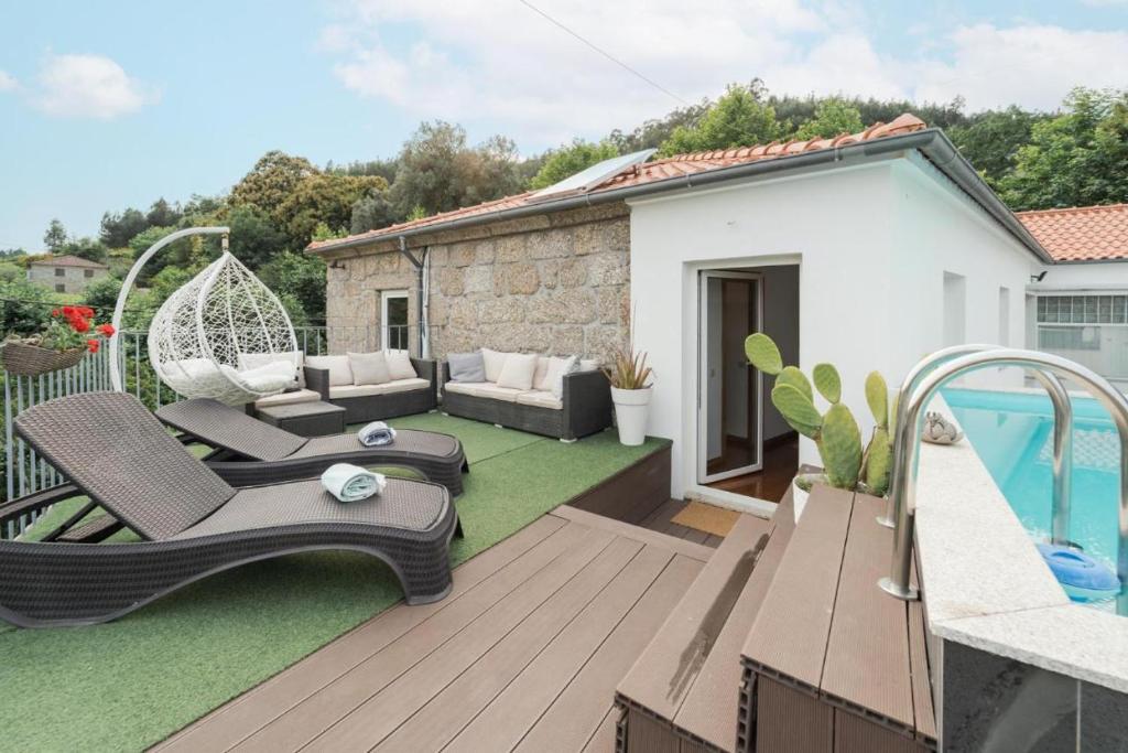 a backyard with a patio furniture and a swimming pool at Casa da Torre in Vieira do Minho