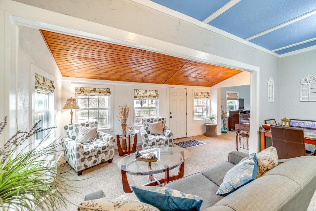 a living room with a couch and a table at Historic Cabin with Yard 1 Mi to Lake Spavinaw! in Spavinaw