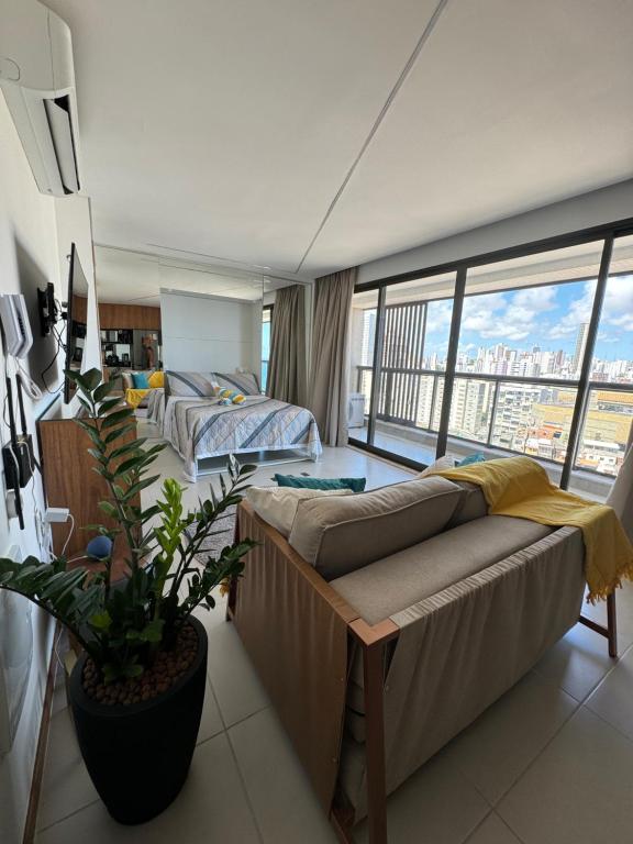 een hotelkamer met 2 bedden en een groot raam bij Studio luxo na Barra para 4 Pessoas in Salvador