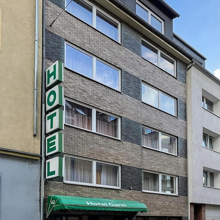 a building with a sign on the side of it at Hotel Ziegenhagen in Cologne