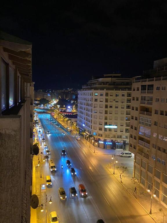 a busy city street at night with cars on the road at Tanger City in Tangier