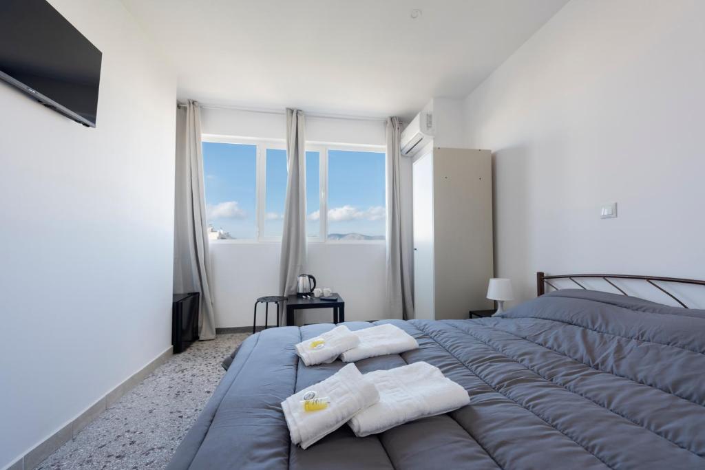 ein Schlafzimmer mit einem großen Bett mit Handtüchern darauf in der Unterkunft Liberal Gazi in Athen