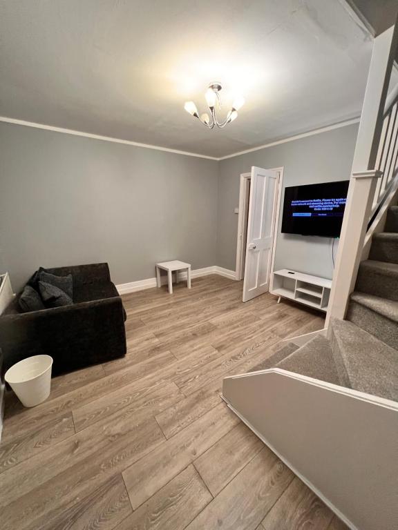 a living room with a couch and a television at 82a Nelson Street in Kettering