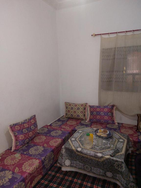 a living room with a couch and a table at Dar Dyafa in Er Rachidia