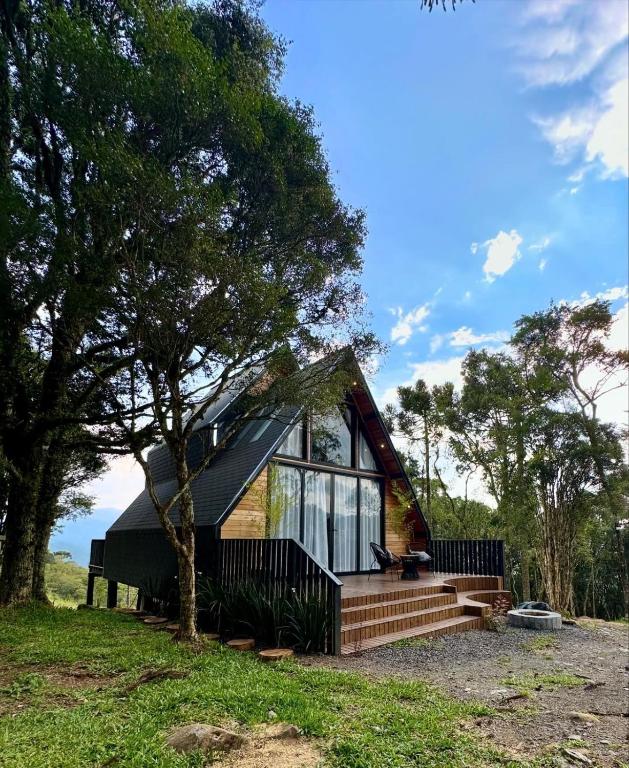 a small house with a large window and stairs at Cabana The Wild Urubici in Urubici
