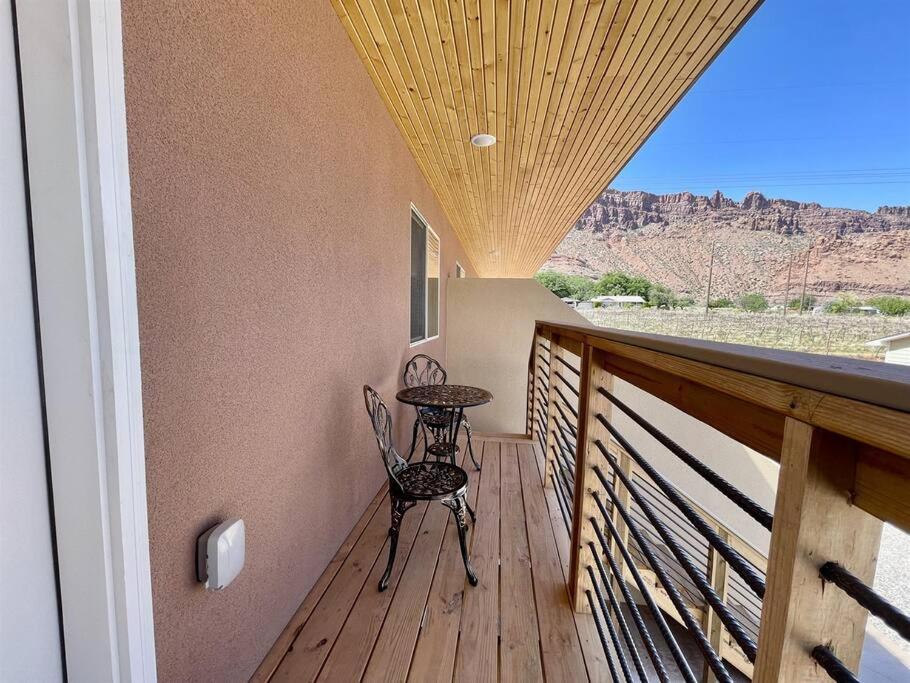 a porch with a table and chairs on a balcony at Angel Rock Rentals of Moab Unit 10 in Moab