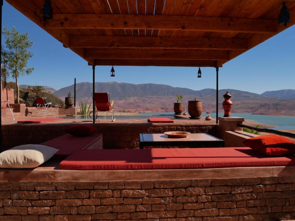 a bed on a patio with a view of the mountains at House of dreams in bin el ouidane in Bine el Ouidane