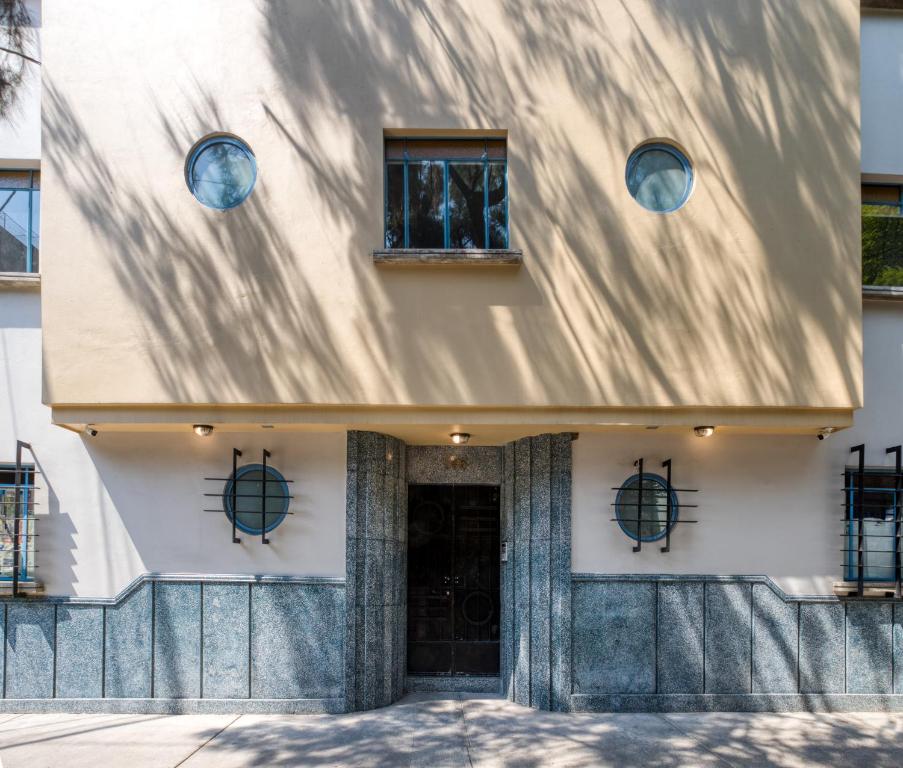 un edificio con dos ventanas y una puerta en Vicente Suarez Vintage By Mr W, en Ciudad de México
