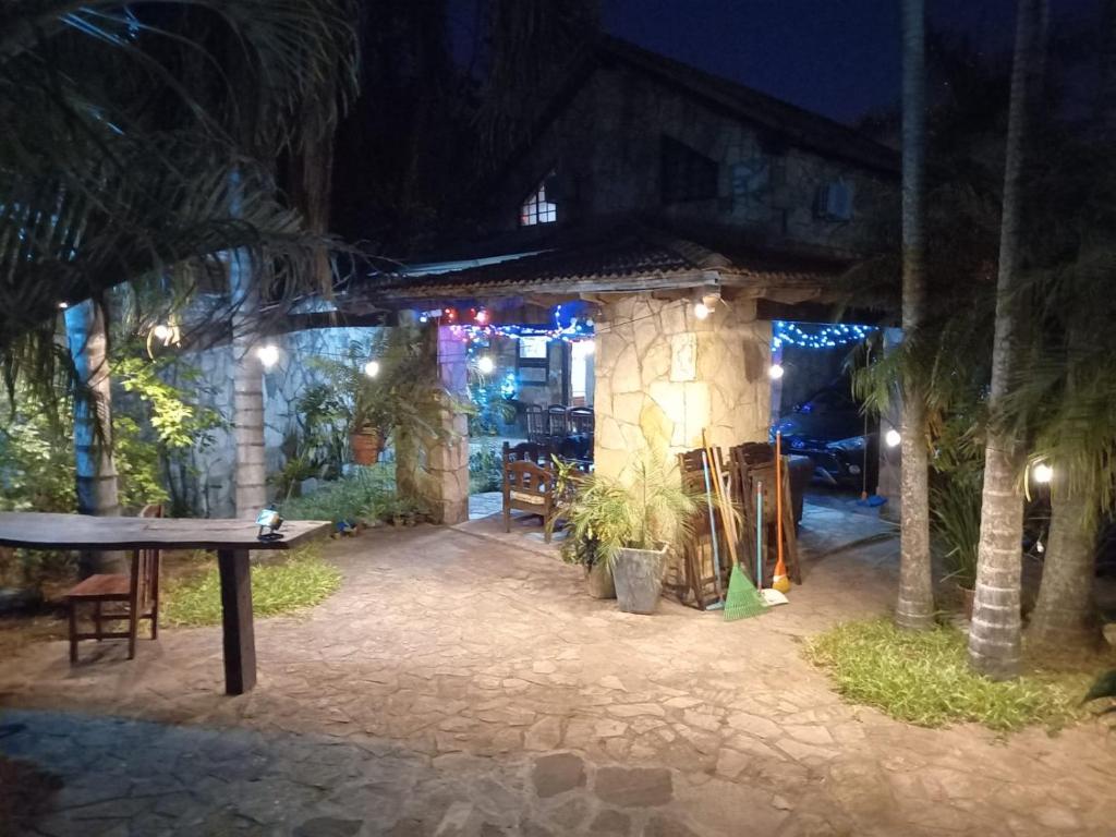 a ping pong table in a courtyard at night at Cabaña Las Palmeras in San Bernardino