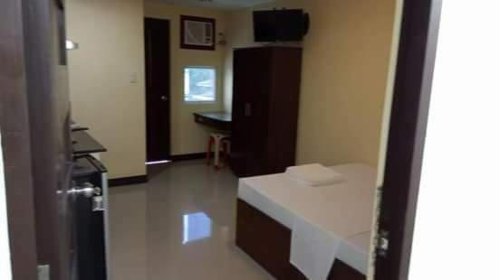 a room with a white bench in a room at Argao Aballe Pension House/Apartelle in Argao