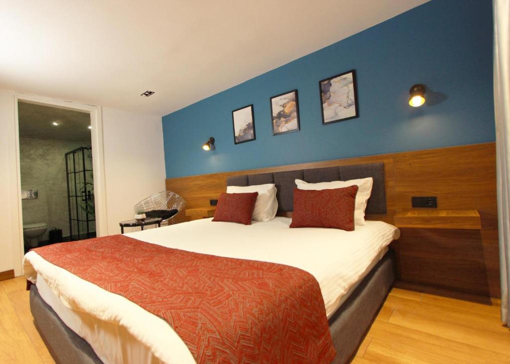 a bedroom with a large bed with a blue wall at Besiktas KonukEvi in Istanbul