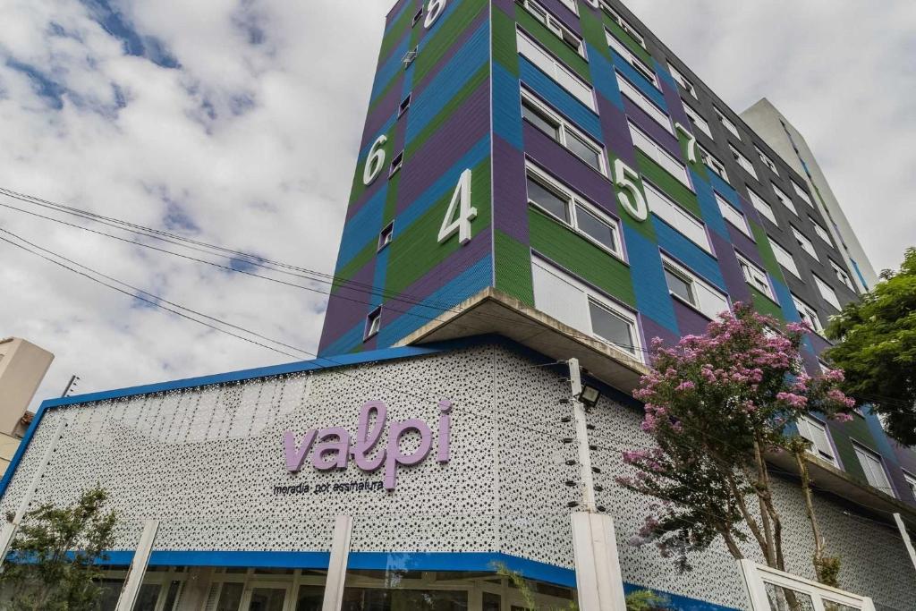 a tall building with a sign on the side of it at Valpi NB Living in Porto Alegre