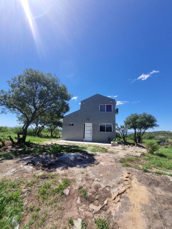 a house in the middle of a field at La Loma del Valle in Tanti
