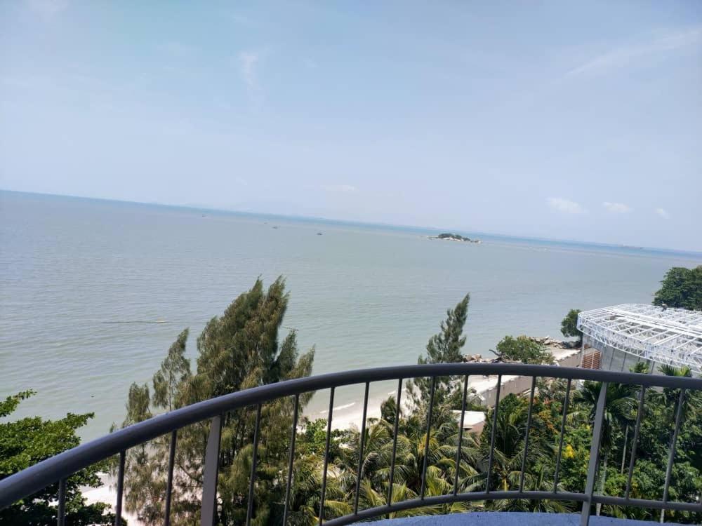 a view of the ocean from a balcony at Beachfront full sea penang in Tanjung Bungah