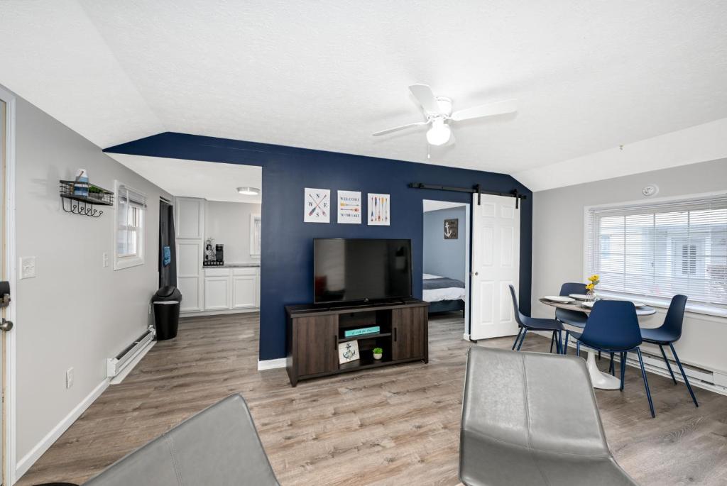 a living room with a blue wall and a table and chairs at Recharge and Reconnect Your cozy Vermilion nest in Vermilion