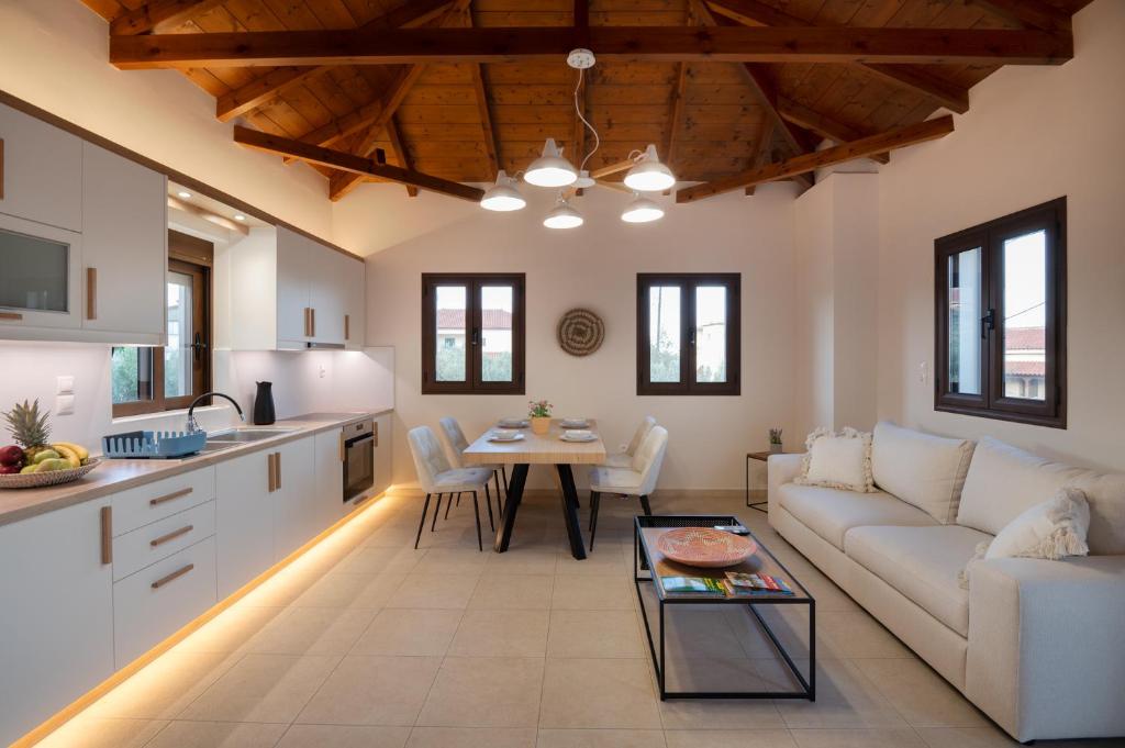 a living room with a couch and a table at Stoupa Harmony Suites - Two Bedroom Apartment in Stoupa