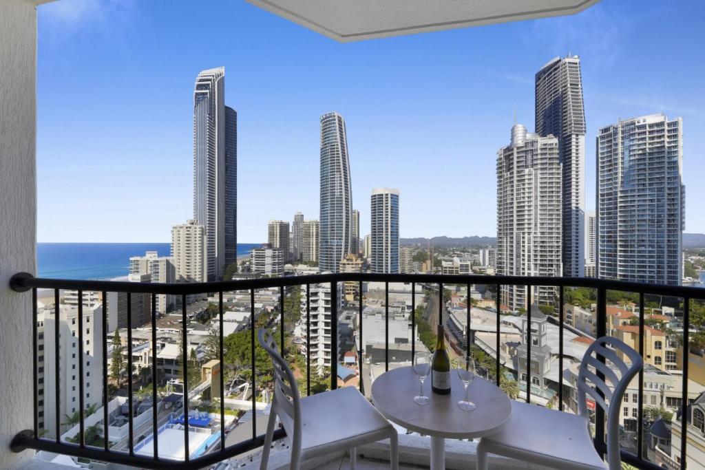 a balcony with a table and chairs and a view of the city at Ocean View Studio with Rooftop Jacuzzi in Gold Coast