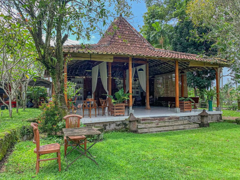 a house with a gazebo in the yard at Carla Garden Villa in Yogyakarta