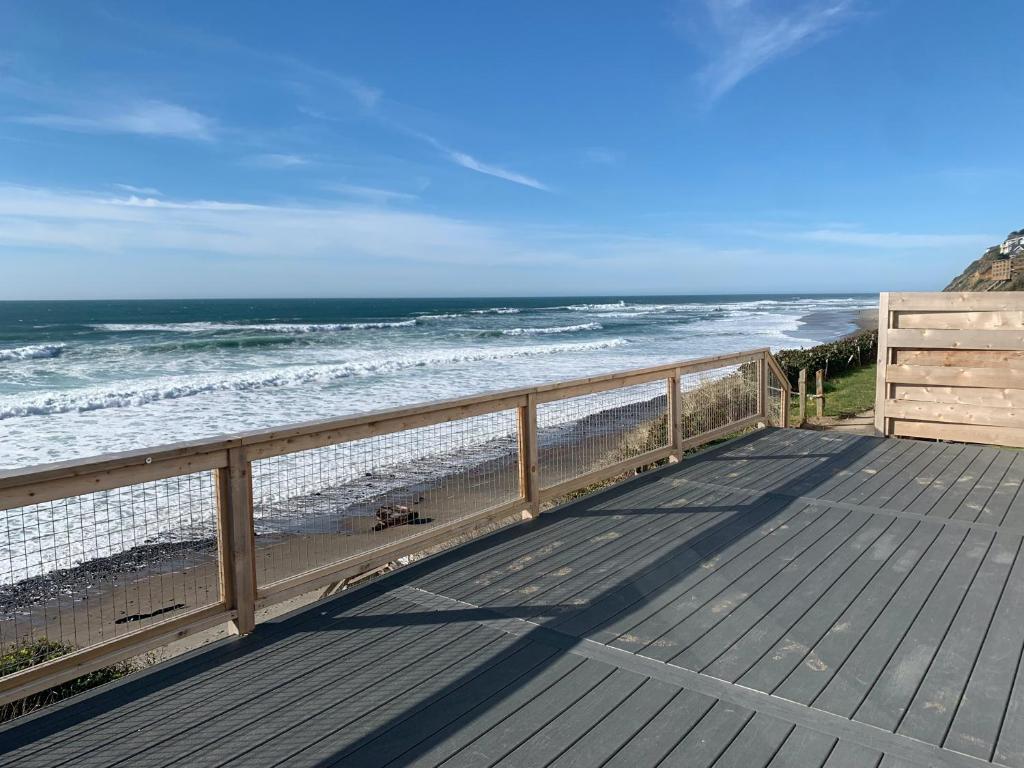 a wooden deck with a view of the beach at West Beach Suites in Lincoln City