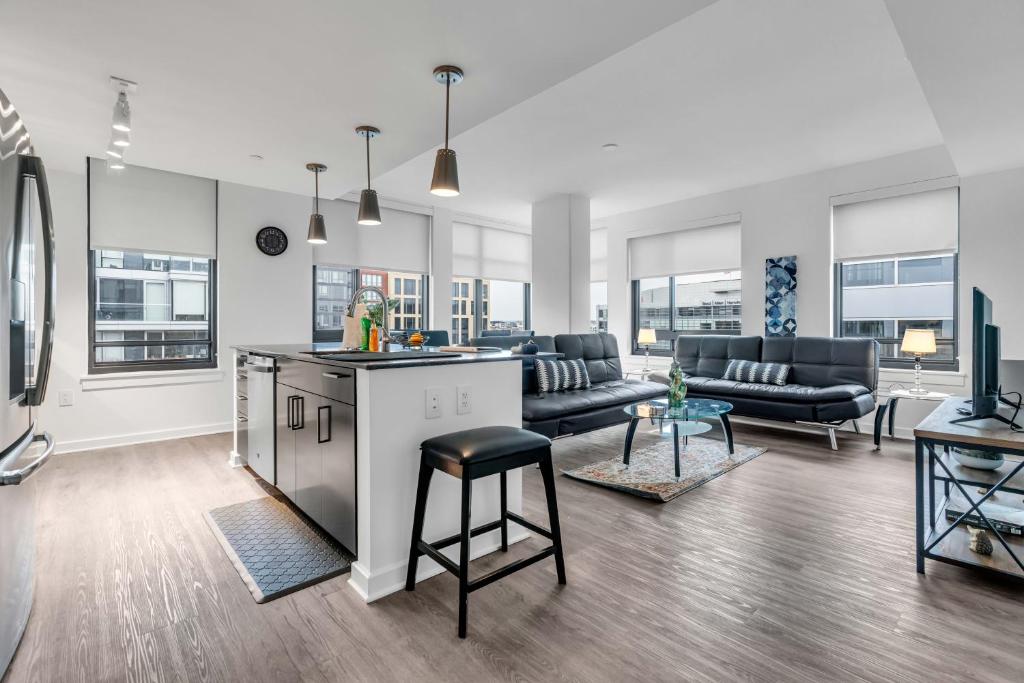 an open living room with a kitchen and a living room at Waterfront Two Bedroom apartment in a brand new building apts in Washington
