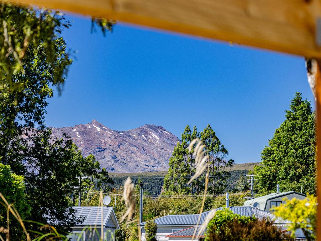 a view of a mountain with trees and houses at Alpine Rest - National Park Holiday Home in National Park