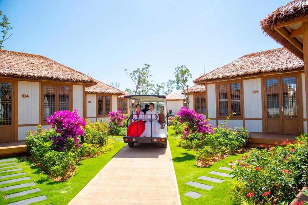 a golf cart in front of a building at K-Town Resort Phan Thiet in Phan Thiet