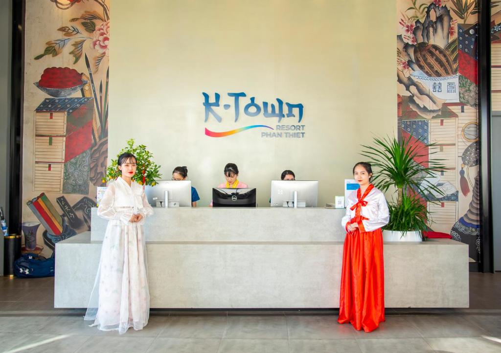 two women in kimonos standing in front of a counter at K-Town Resort Phan Thiet in Phan Thiet