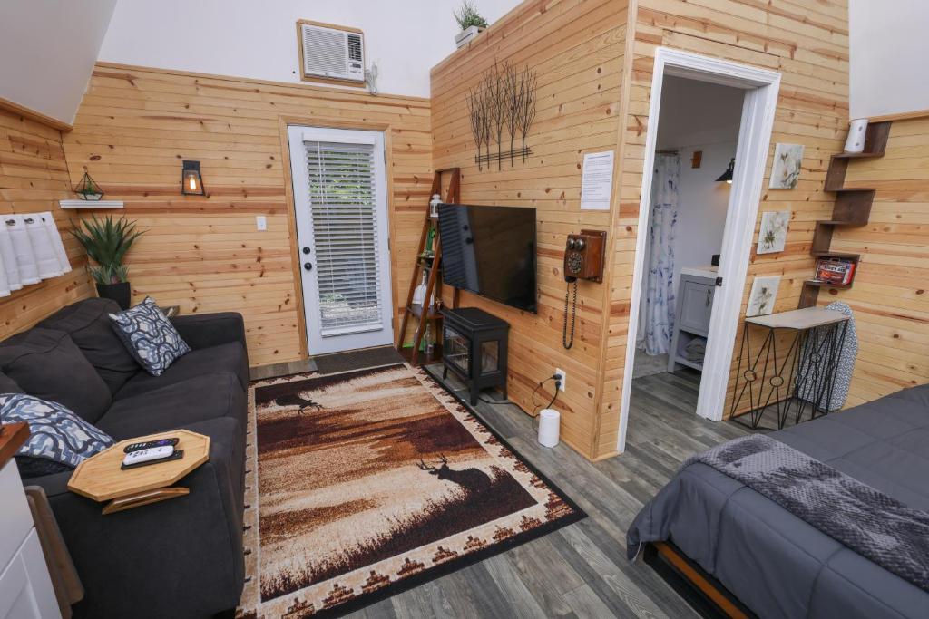 a living room with a couch and a tv at Peaceful Barn Getaway Fire Pit & Daybed FREE PK in Atlanta