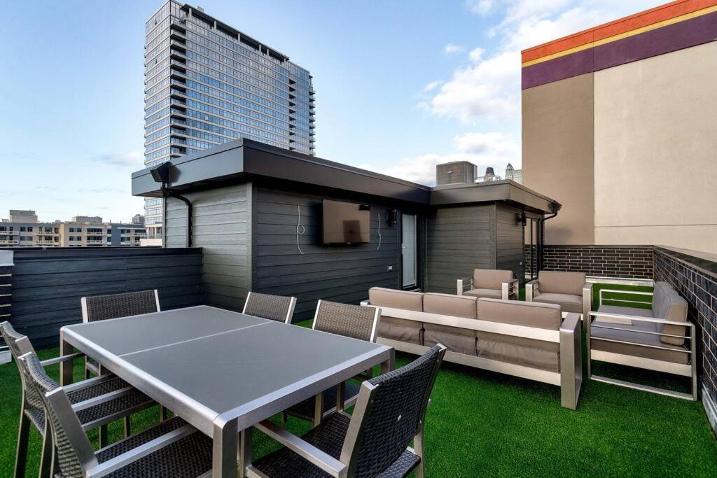 a patio with a table and chairs and a building at 2 Newly Built Luxury Condos with Private Roofdeck in Chicago