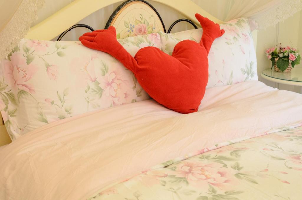 a bed with two red pillows on it at 晶藍色美人魚 Mermaid Inn in Hualien City