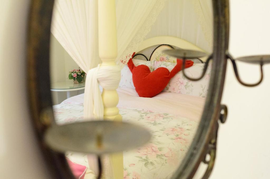 a reflection of a bed in a mirror at 晶藍色美人魚 Mermaid Inn in Hualien City