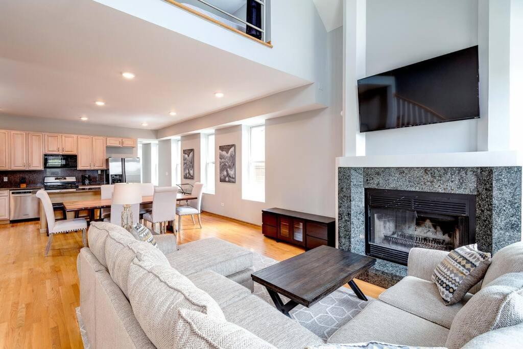 a living room with a couch and a fireplace at Stunning 2 Floor Penthouse Downtown in Chicago