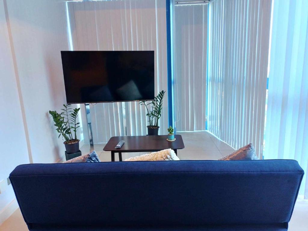 a living room with a blue couch and a table at 38 Park Avenue condominium, IT Park in Cebu City