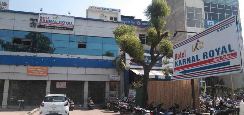 a building with motorcycles parked in front of it at OYO Flagship Karnal Royal in Karnal