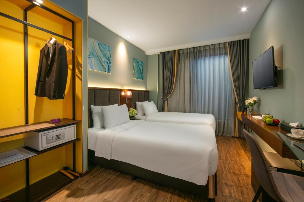 Postel nebo postele na pokoji v ubytování GRAND CITITEL Hanoi Hotel & Spa