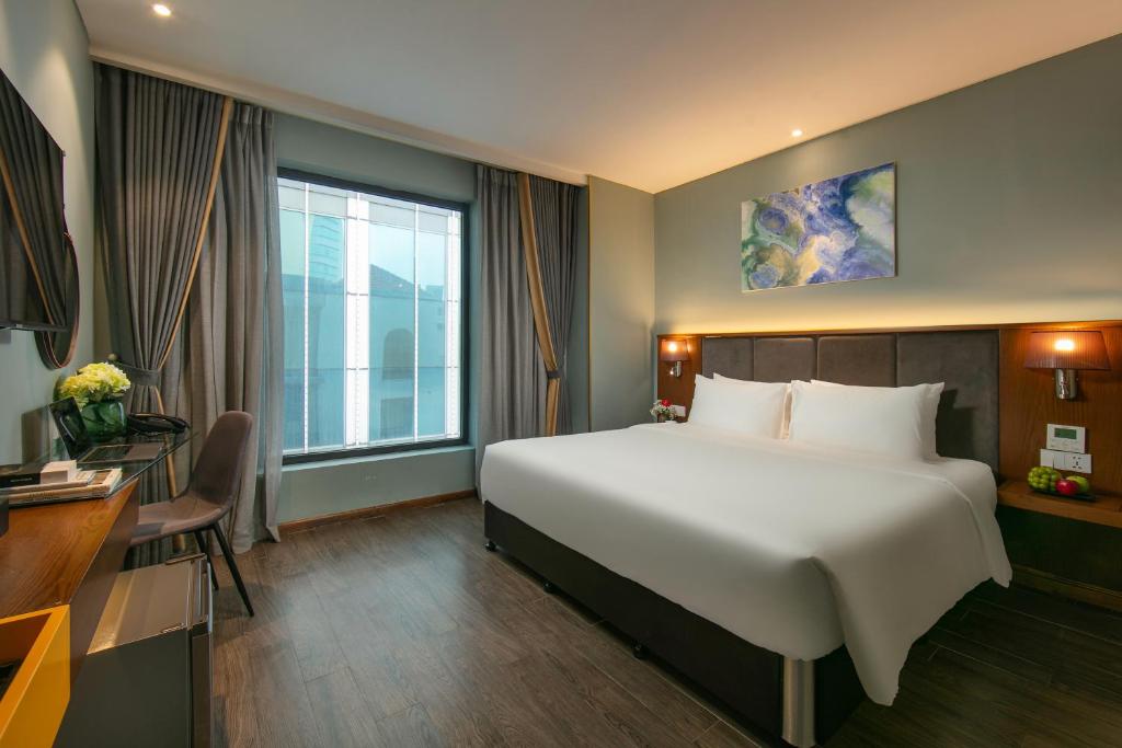 Postel nebo postele na pokoji v ubytování GRAND CITITEL Hanoi Hotel & Spa