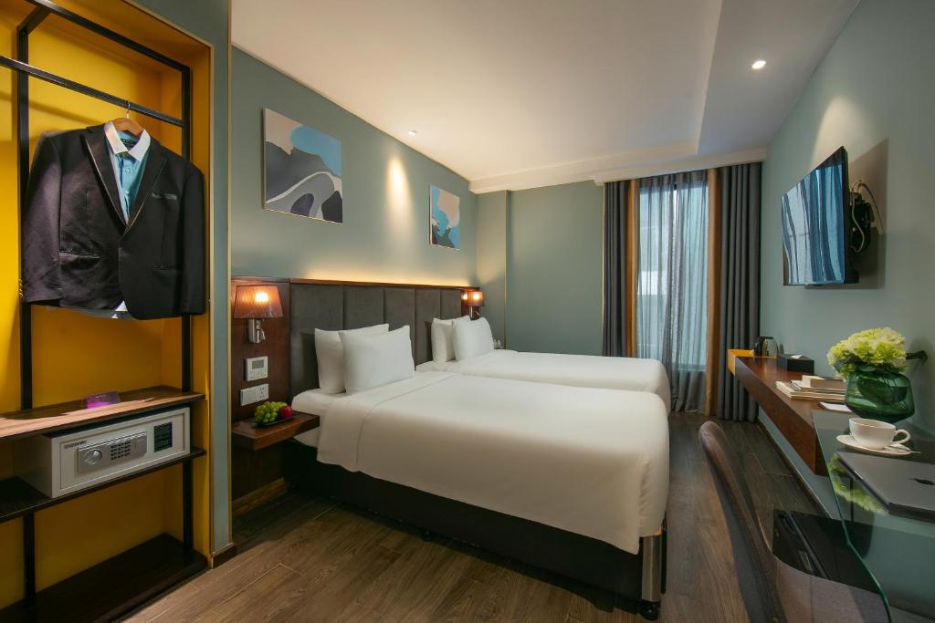 Postel nebo postele na pokoji v ubytování GRAND CITITEL Hanoi Hotel & Spa