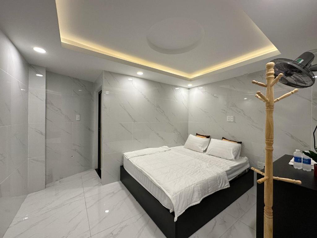 a small bedroom with a bed and a ceiling at Victoria Hotel in Ho Chi Minh City