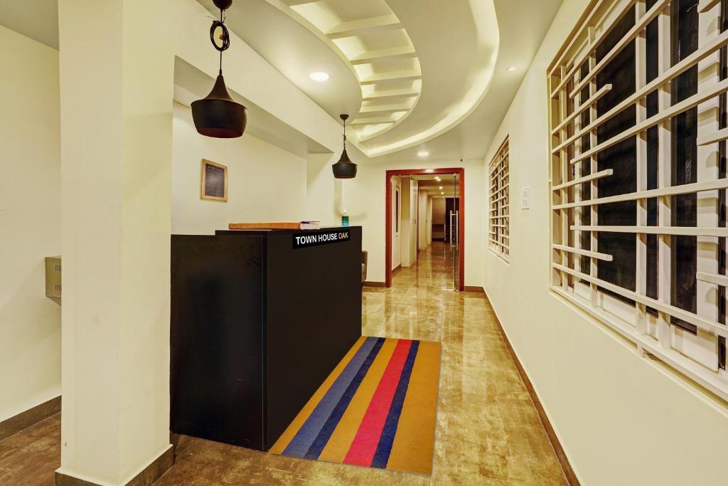 a hallway with a colorful rug on the floor at Super Capital O De Alphabet Kakinada in Kākināda