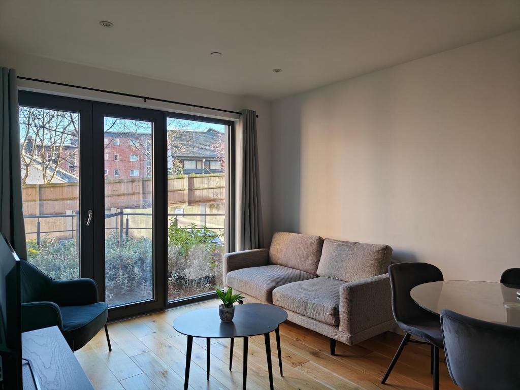a living room with a couch and a table at New Deluxe Birmingham City Centre Apartment 3 Bed in Birmingham
