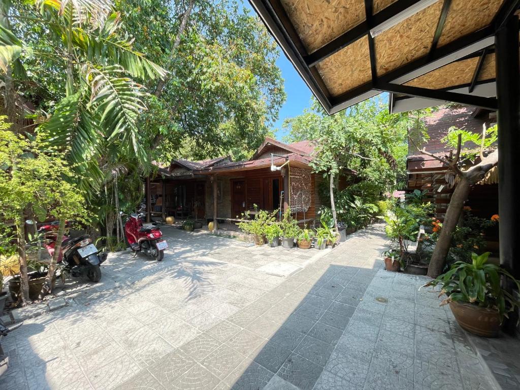 a house with a motorcycle parked in front of it at Samed sand sea resort in Ko Samed