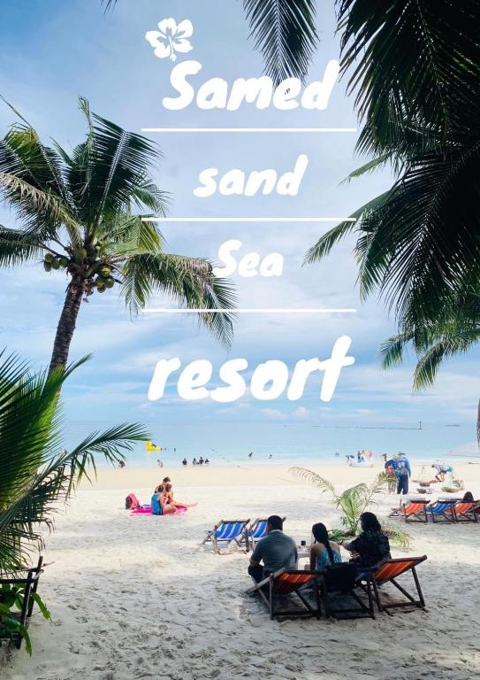 a group of people sitting in chairs on a beach at Samed sand sea resort in Ko Samed