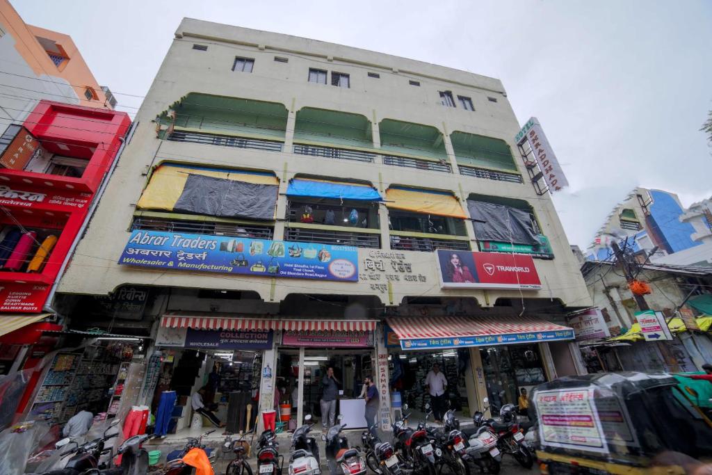 un edificio alto con moto parcheggiate di fronte di SPOT ON Shraddha Hotel a Nagpur