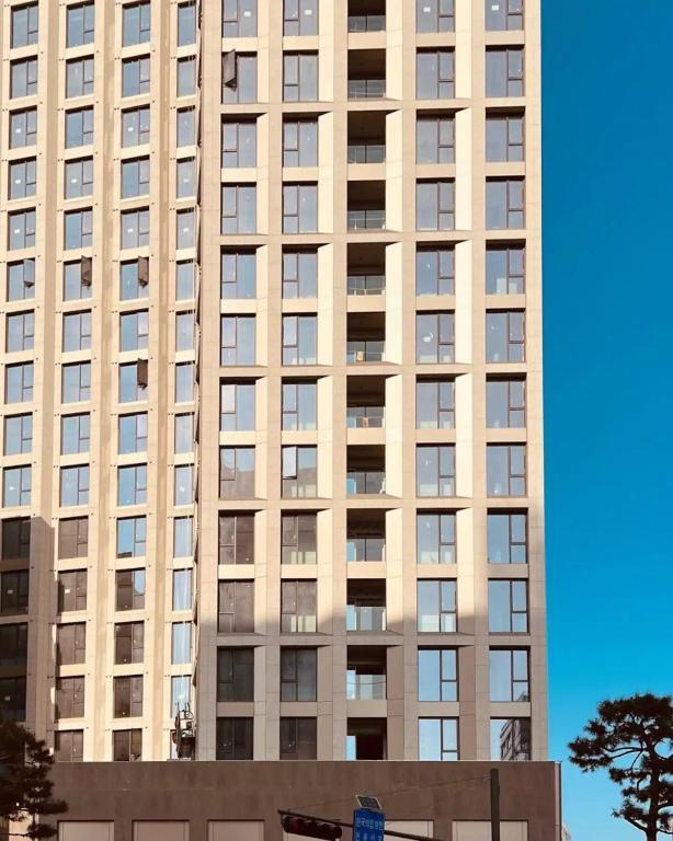 a tall building with many windows in front of it at WECO STAY Namsan in Seoul