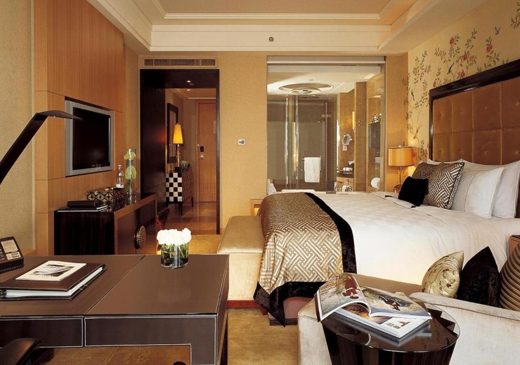 a hotel room with a bed and a desk at Empire inn Suites Hotel Near Delhi Airport in New Delhi
