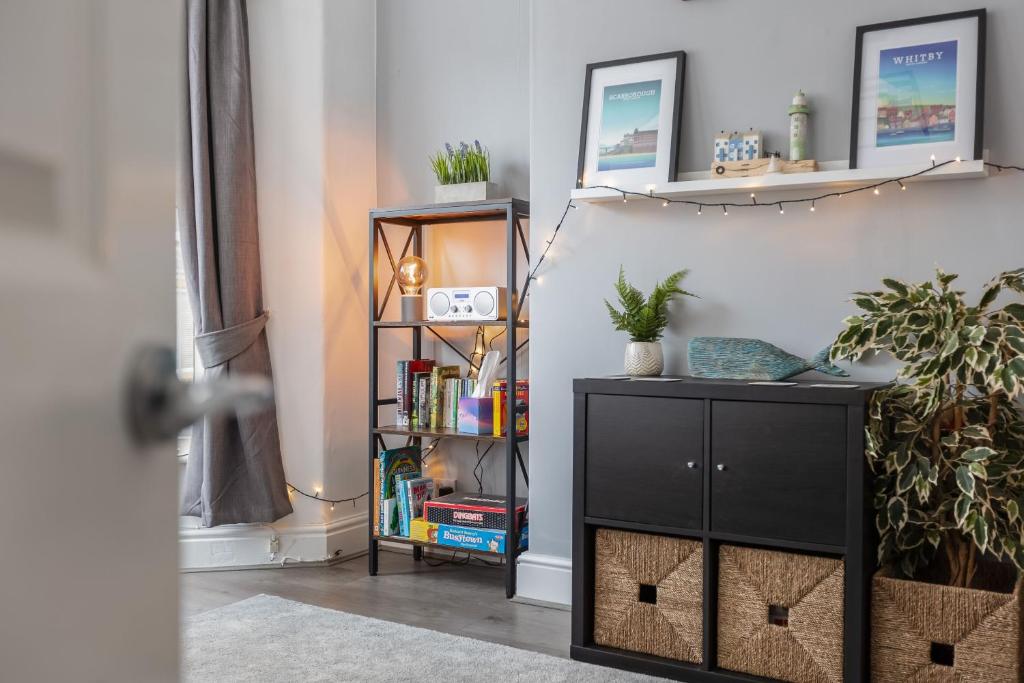 a room with a book shelf and a black cabinet at Coastal Escape close to North Bay- Pet Friendly in Scarborough