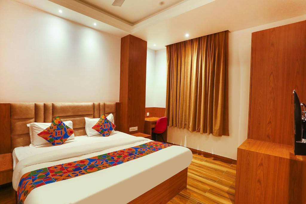 a hotel room with a bed and a television at FabHotel Prime Swarn Bhoomi in Kānpur