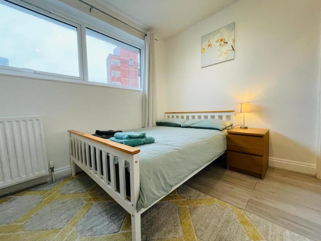 a bedroom with a bed and a large window at Double bedroom with bathroom en suite in London Docklands Canary Wharf E14 in London