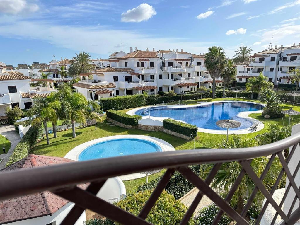 a view from the balcony of a resort with a swimming pool at Coto de Sancti Petri in Chiclana de la Frontera