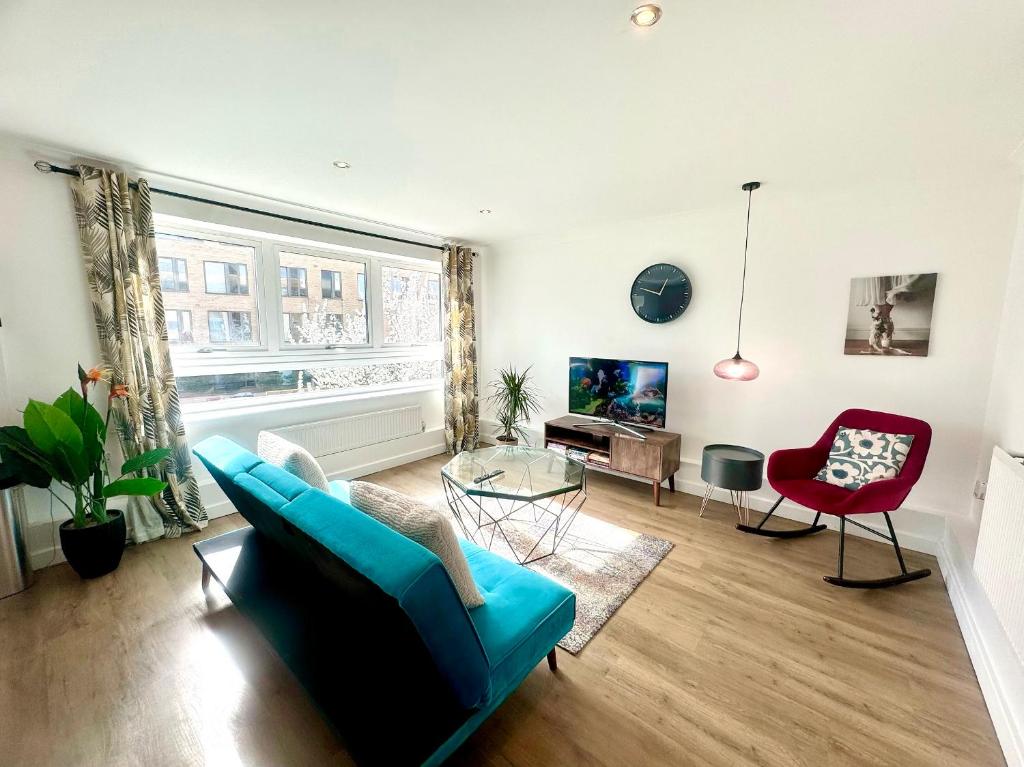 sala de estar con sofá azul y silla roja en Home2 Home - Market Rise en Cambridge
